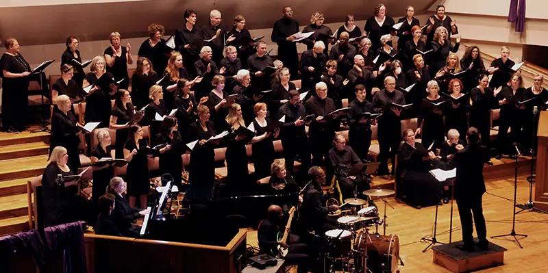 Harmonia Atlanta Chorus performing with drummer, bassist, and pianist